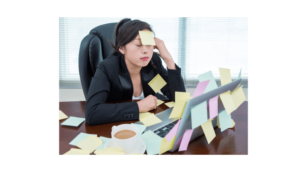 Asian woman with post-it notes all over her and her computer